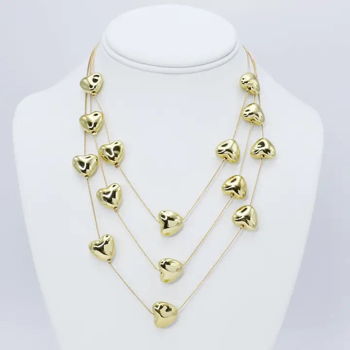 Layered design with heart balloon charms that is gold plated