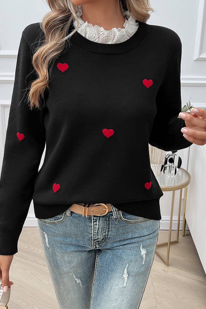 Black long sleeve sweater featuring an embroidered heart design