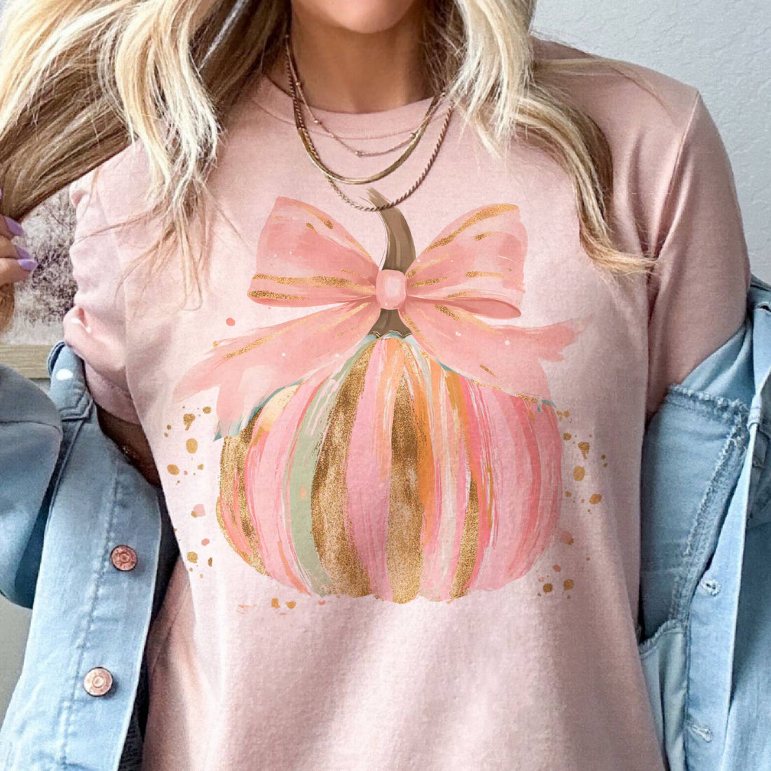 Pink shirt with a bow design worn by a person