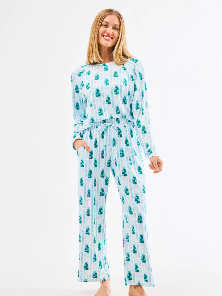 Woman wearing a patterned pajama set on a white background