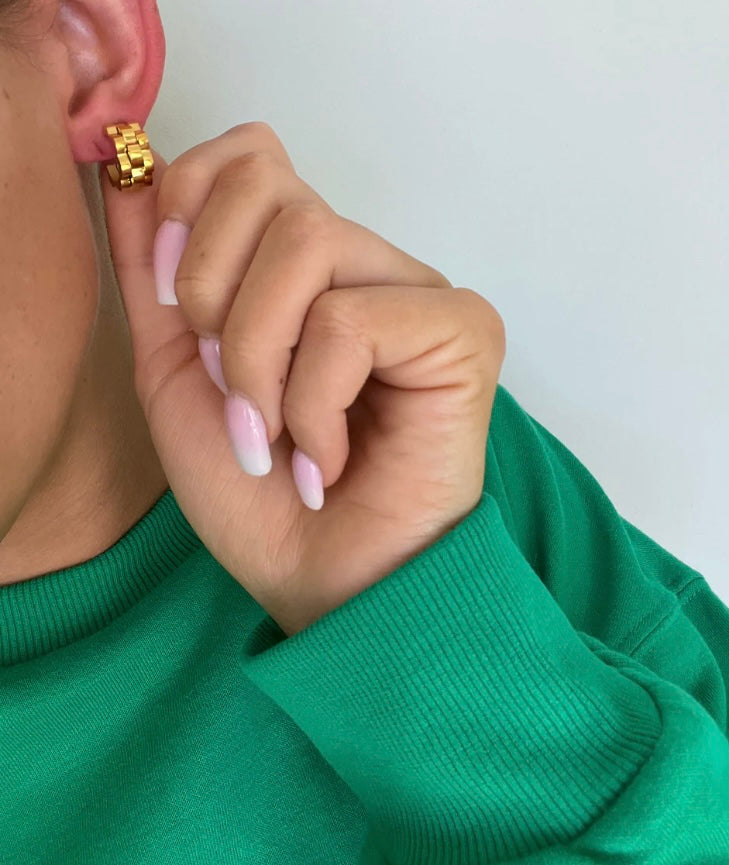 Earrings with bold, blocky design and gold tones