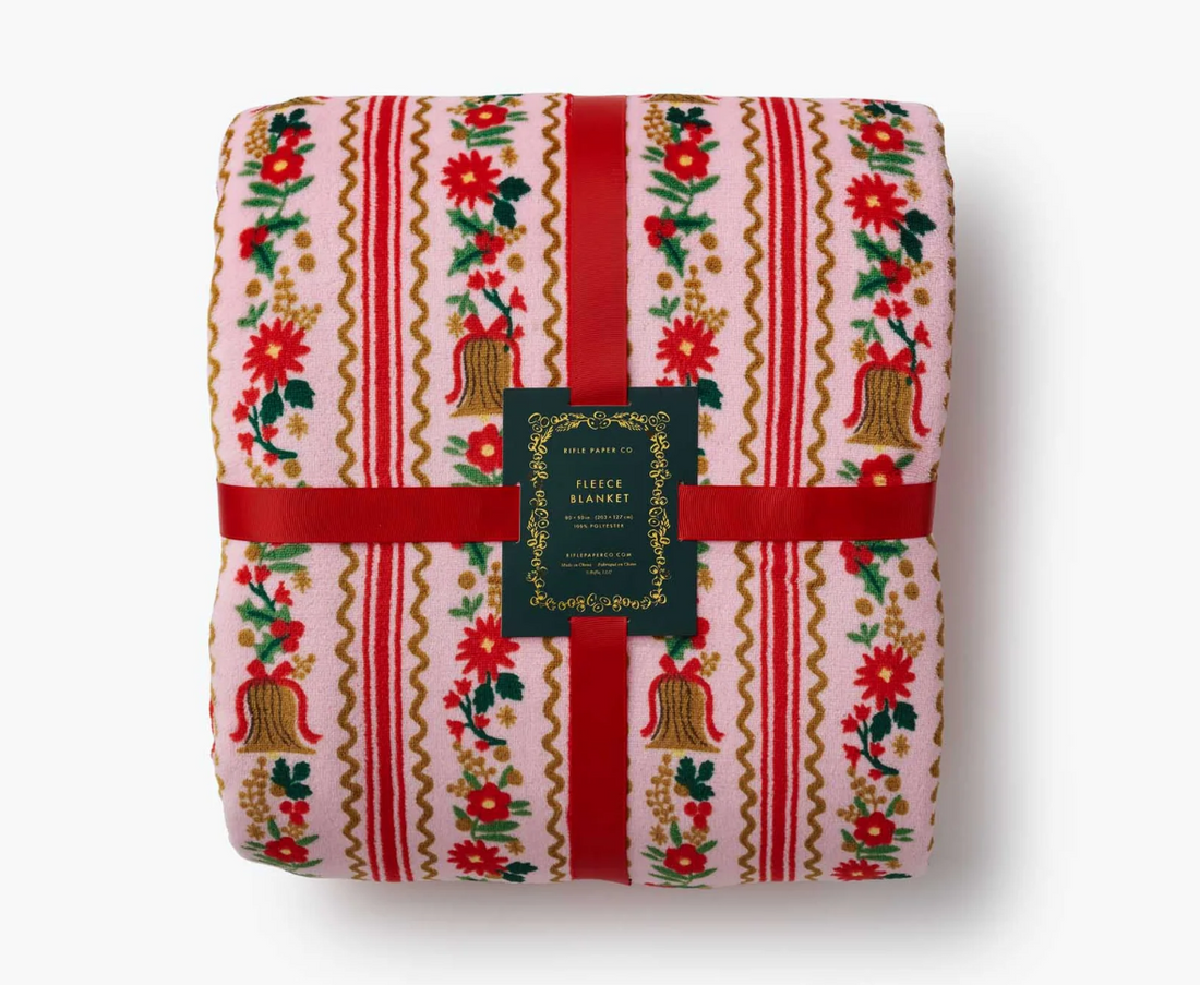 Fleece blanket with festive design on a white background, featuring the Rifle Paper Co. brand.