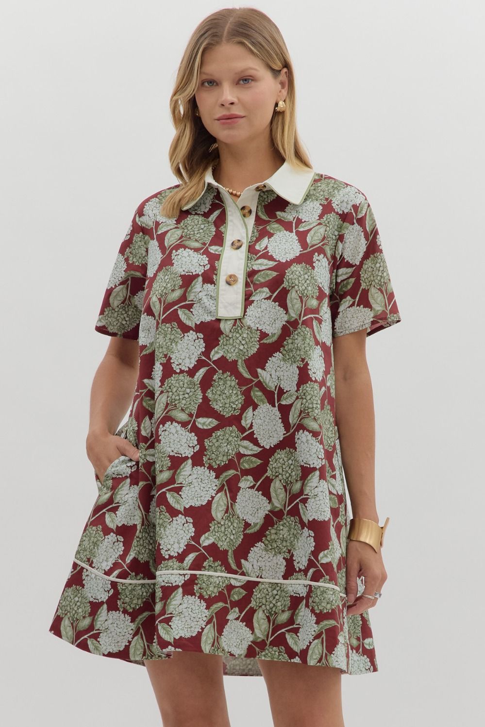 burgundy base, soft green and white floral print, and crisp ivory collar, this collared mini dress