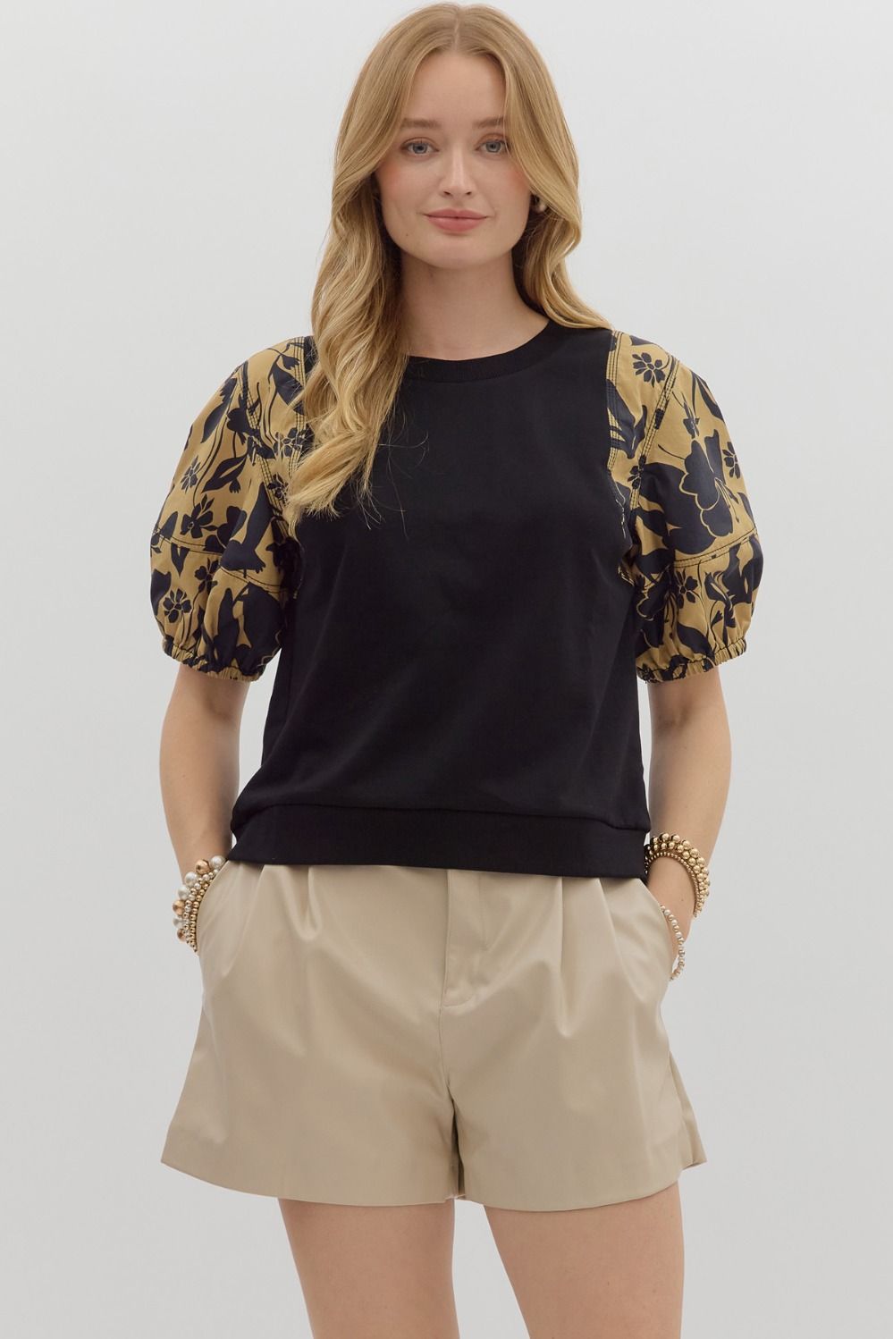 black knit tee gets a bold upgrade with dramatic puff sleeves in a mocha-toned floral print