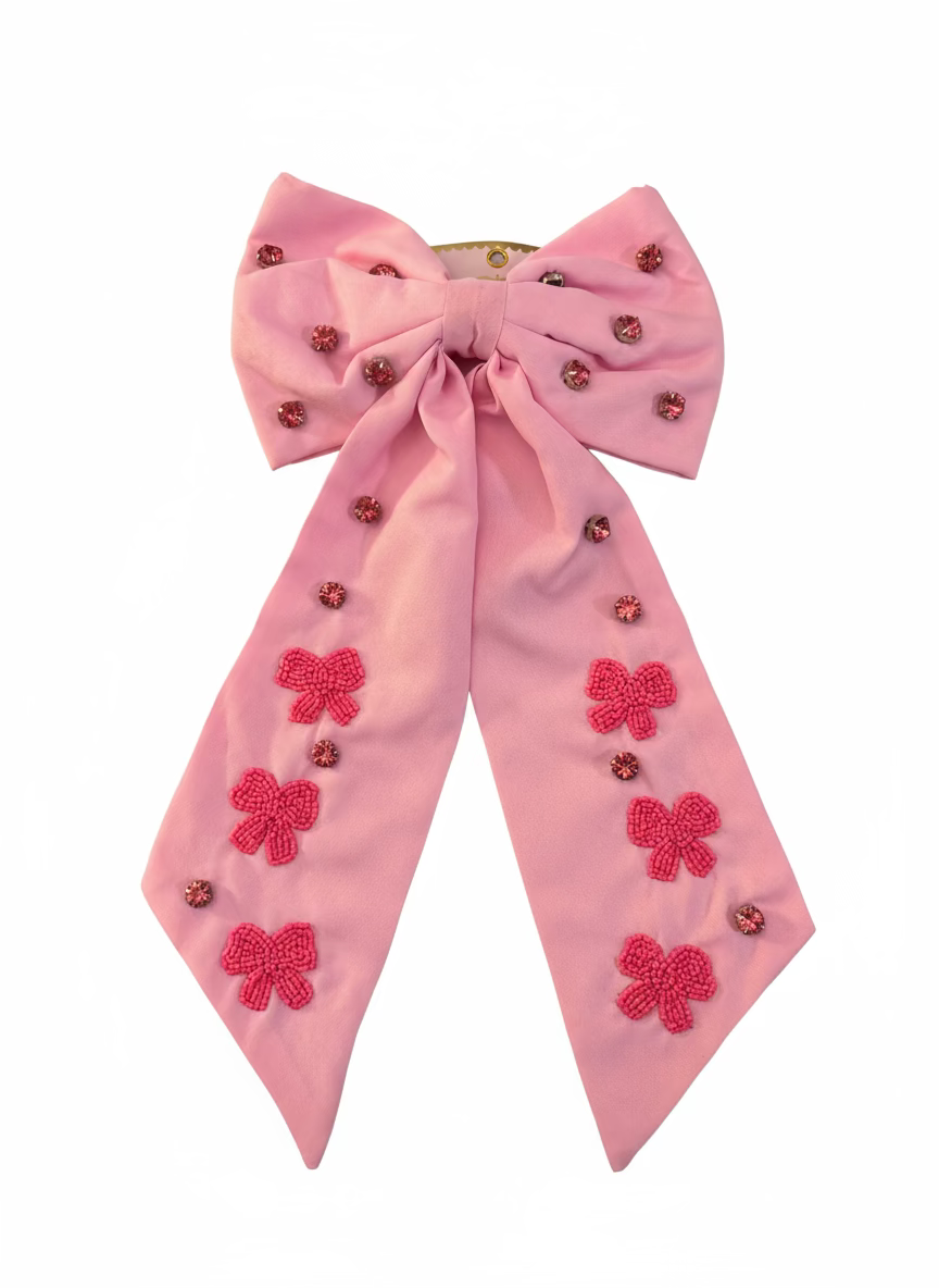 Pink bow with floral embellishments on a light gray background