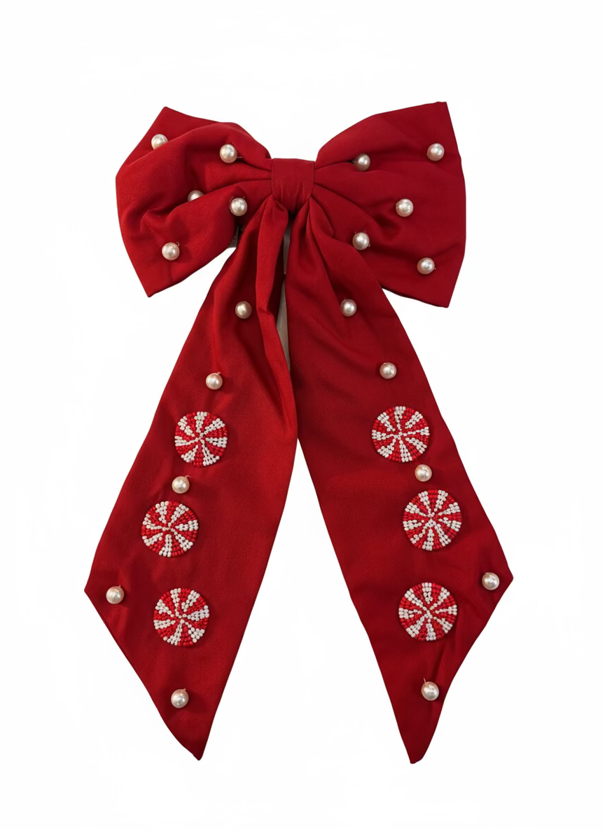 Red bow with white snowflake patterns on a white background