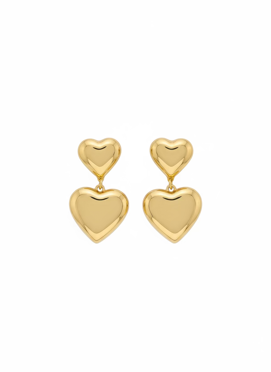 Gold heart-shaped earrings on a branded card with &
