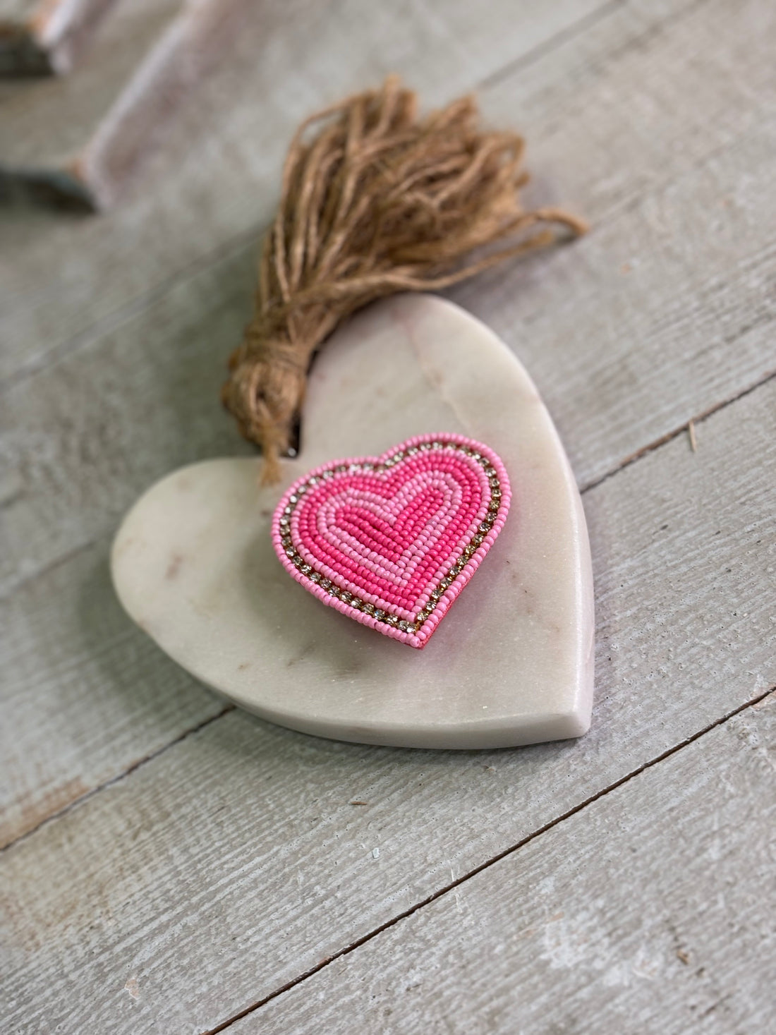 Pink beaded heart pin.