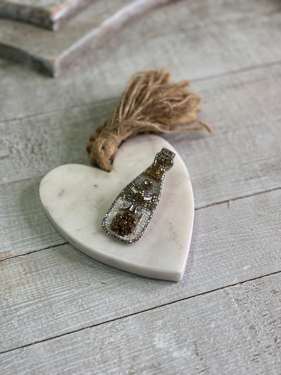 Champagne inspired accessory pin with gold, silver and white accents.