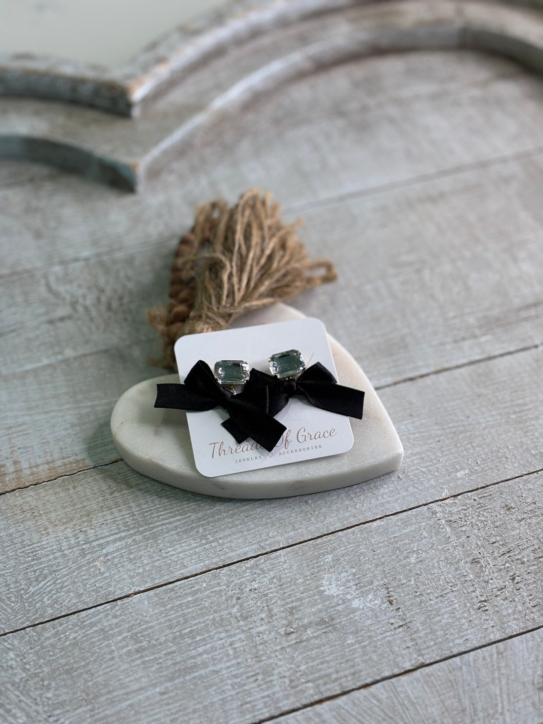 Earrings featuring faceted crystal studs topped with luxe black velvet bows.