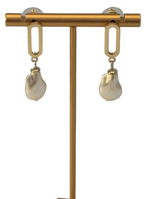 Gold earrings with clear gemstones on a gray background