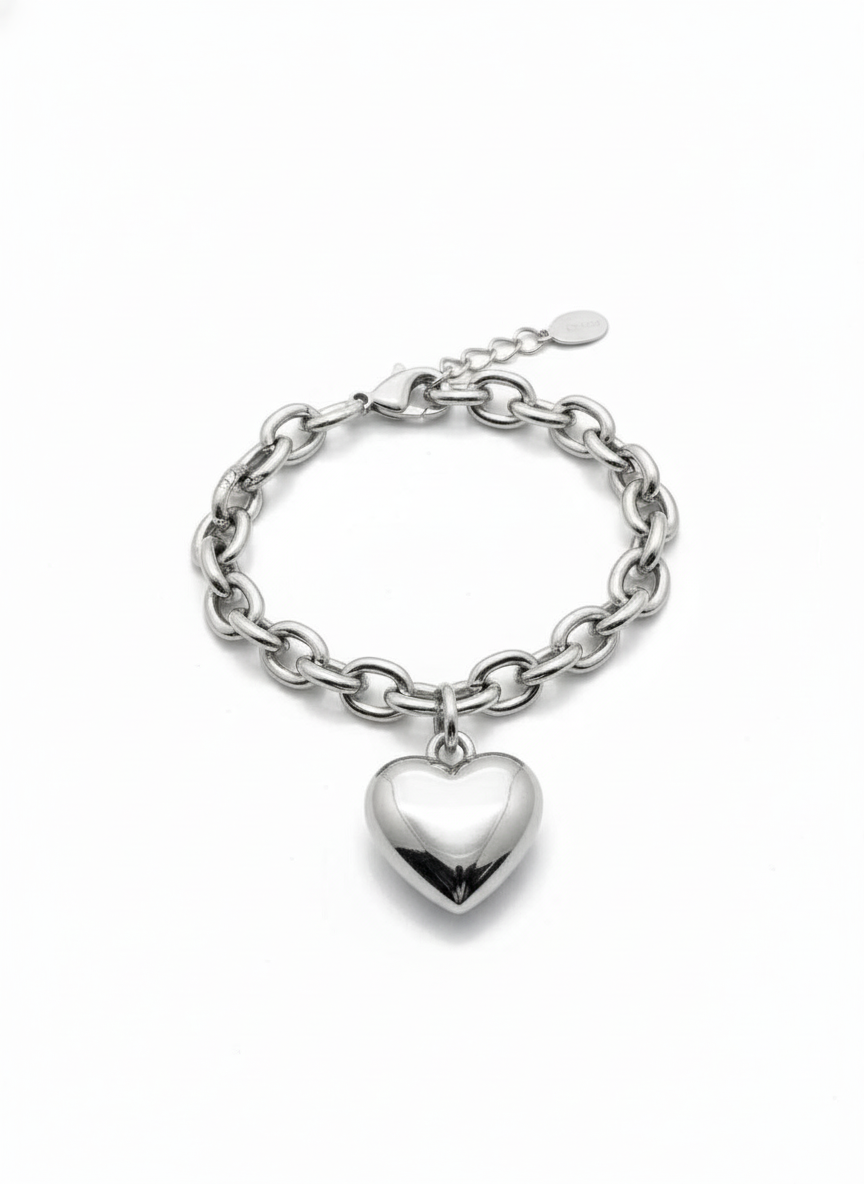 Silver chain bracelet with a heart charm on a white background