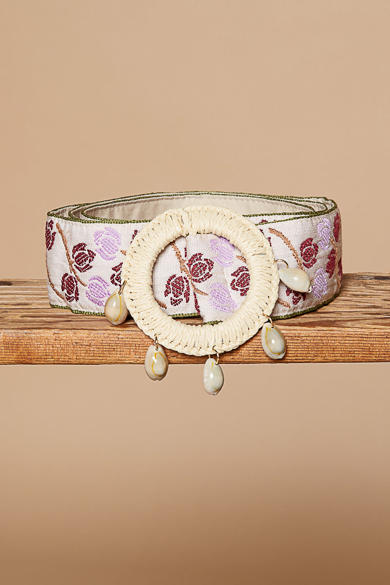 Belt that brings delicate spring vibes with its natural woven band and lavender threading, finished with a white wood-beaded round buckle for that perfect artisan touch.