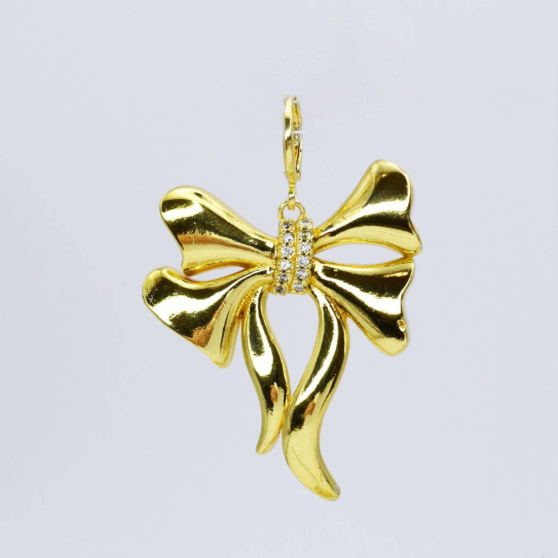 Gold bow charm with crystals in the middle 