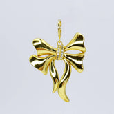 Gold bow charm with crystals in the middle 