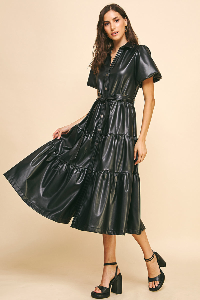 Leather midi dress with a tiered design, button down front, collar, balloon sleeves, side pockets, and stylish belt