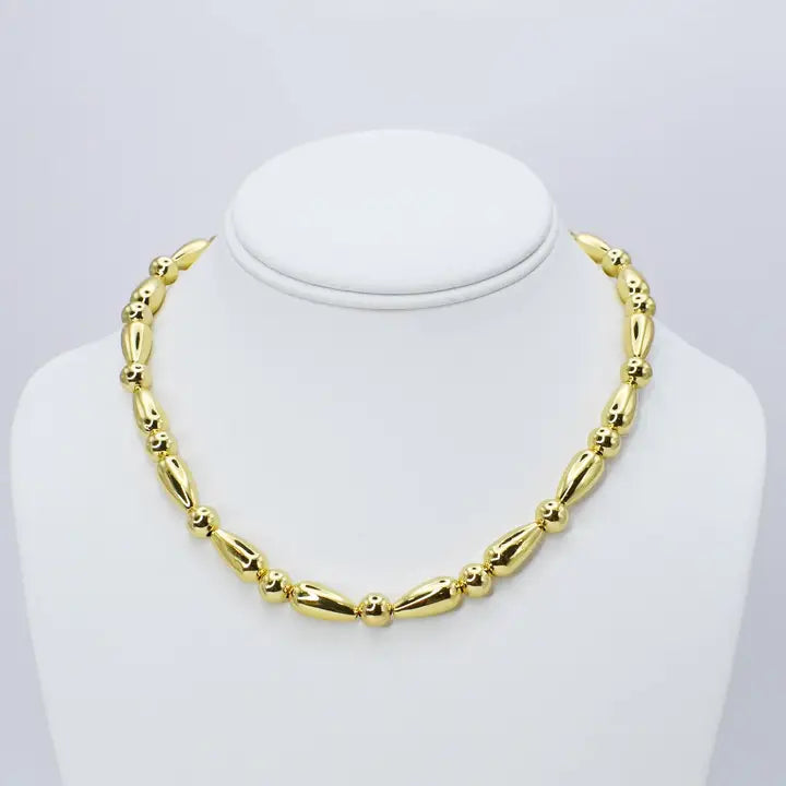 Gold bead necklace with protective clear coat