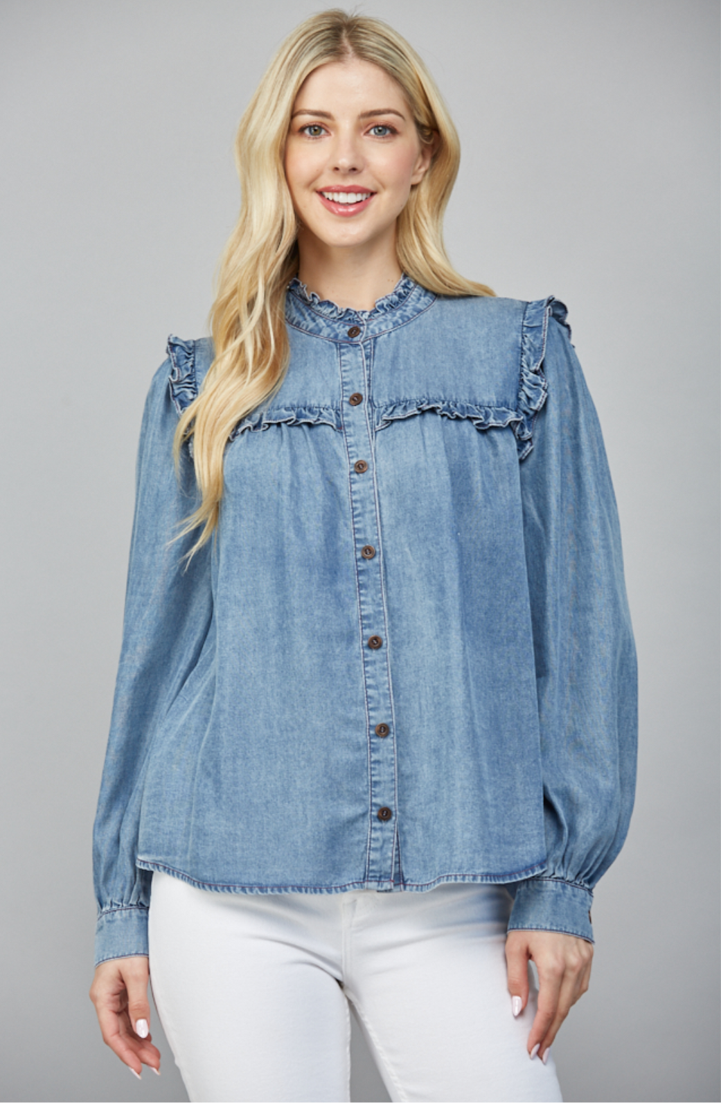 Bluebird Ruffle Denim Top with button front, long sleeves, and ruffle detailing on shoulders and chest