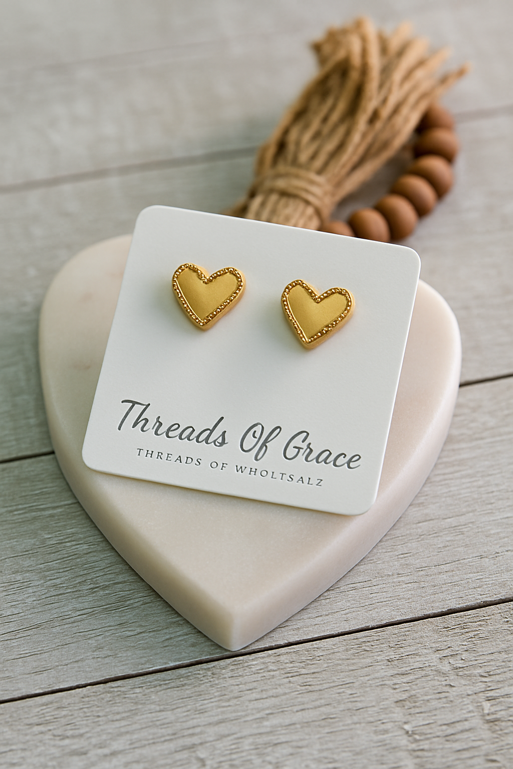 Gold heart-shaped stud earrings with minimalist design