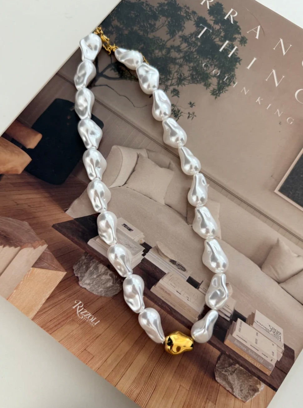 Baroque pearl necklace with gold accent bead in middle 