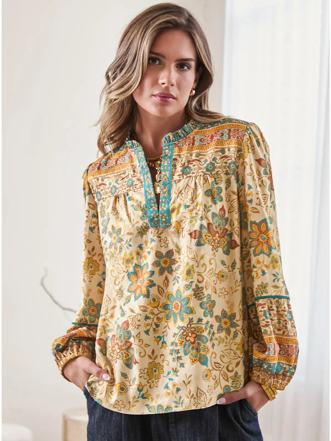 breezy woven blouse features a rich mosaic of golden florals, turquoise accents, and intricate border details