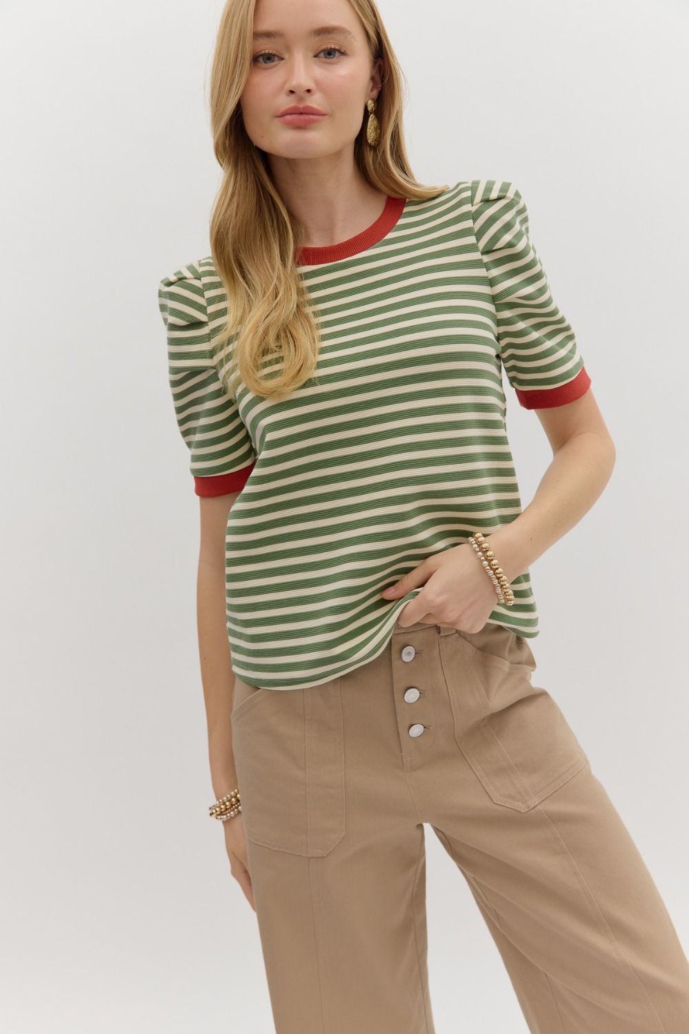 striped knit that’s anything but basic. With olive and cream stripes and bold rust red contrast trim at the collar and cuffs