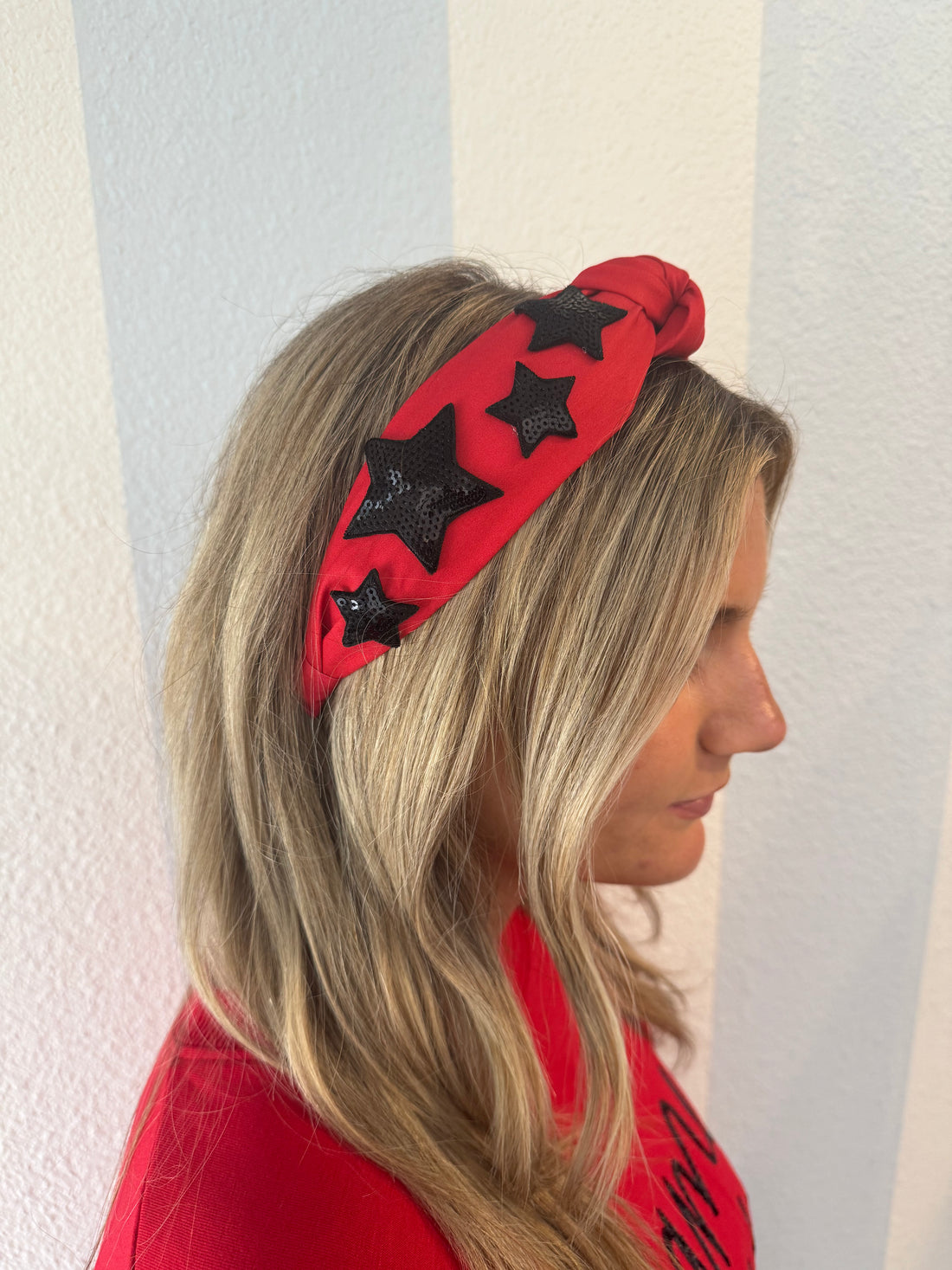 Red knotted headband with black sequin stars 