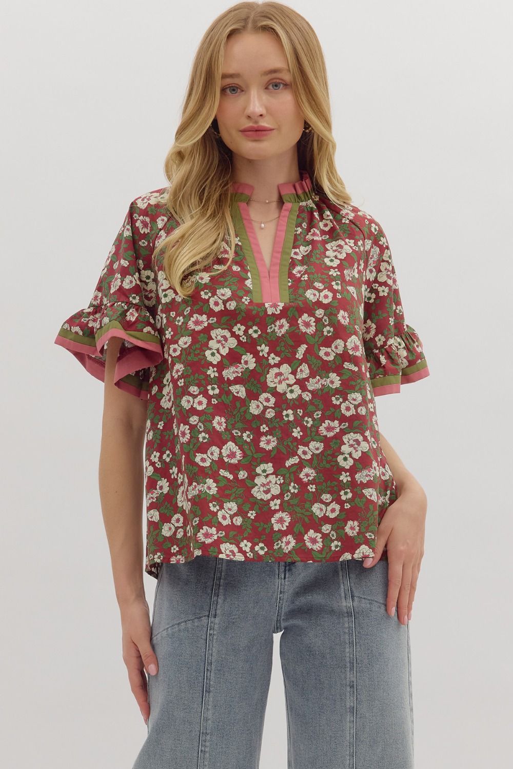 Berry Blossom Blouse featuring berry background with ivory floral print, contrast trim neckline, and ruffle sleeves
