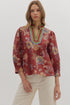 Autumn Sonata Blouse in terracotta with multicolor floral print, scalloped neckline trim, and 3/4 puff sleeves