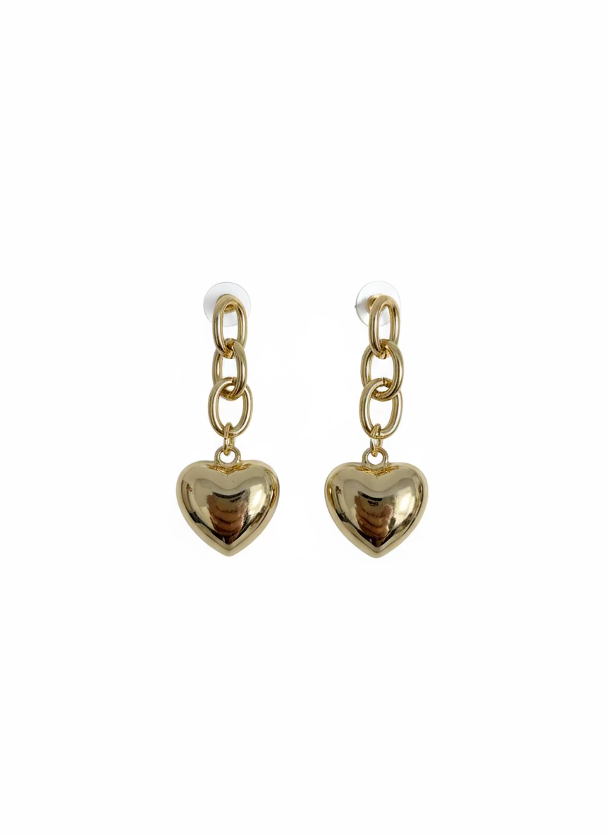 Gold heart-shaped earrings on a wooden surface