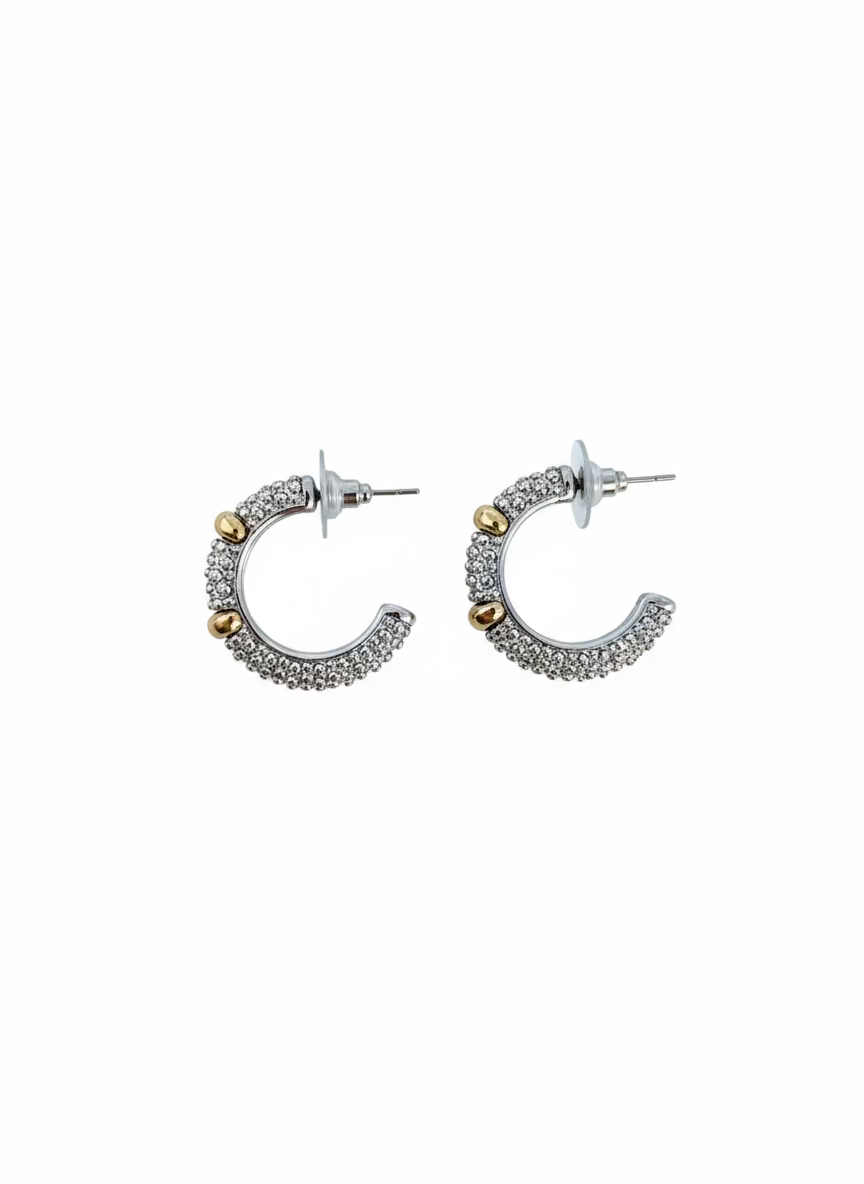 Pair of silver hoop earrings on a wooden surface