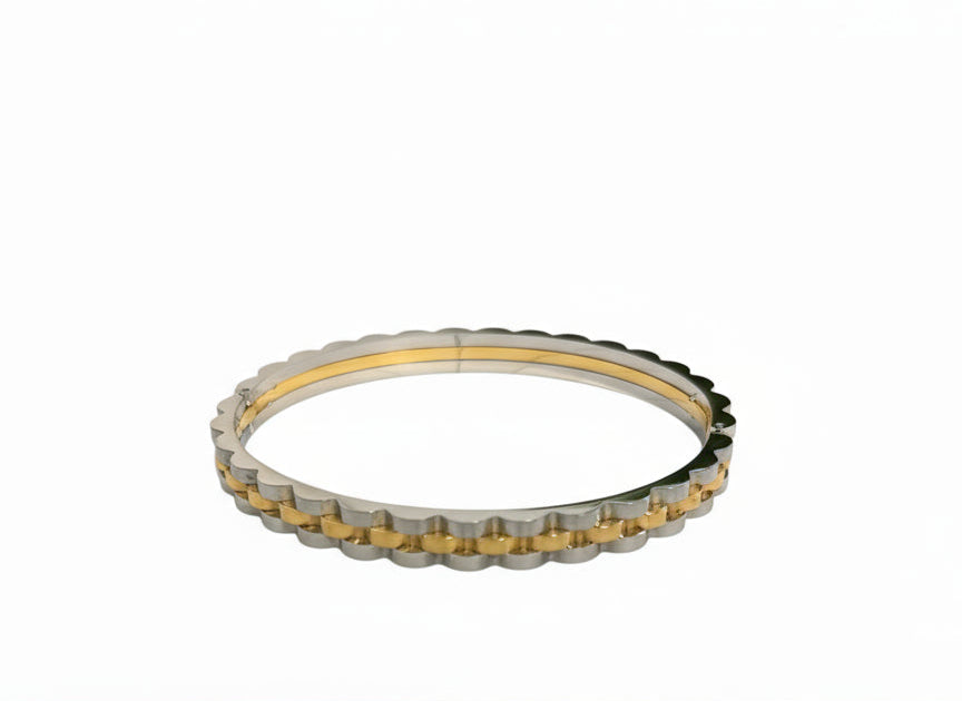 Gold and silver bracelet with a white background