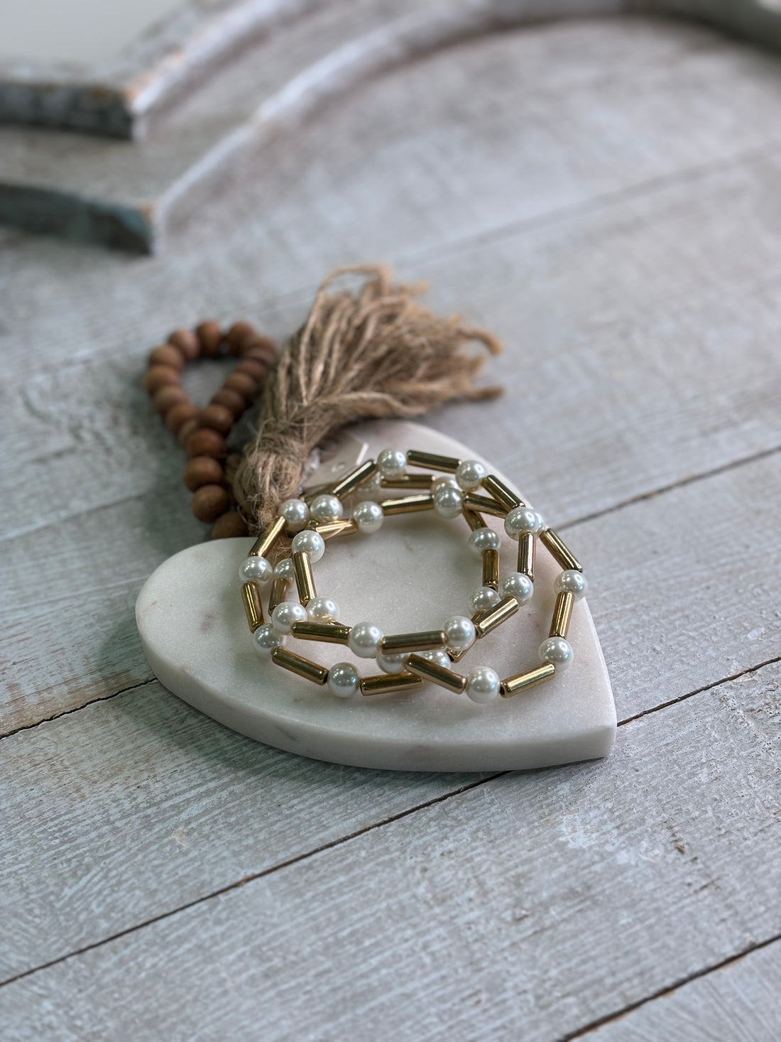 A bracelet that brings together radiant faux pearls and sleek gold bars in a stretch design that&