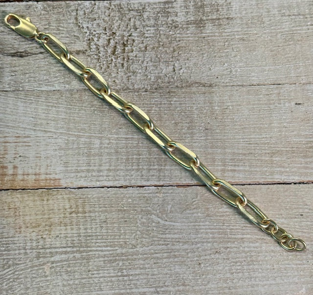 Matte gold-tone oversized links bracelet with lobster claw closure.