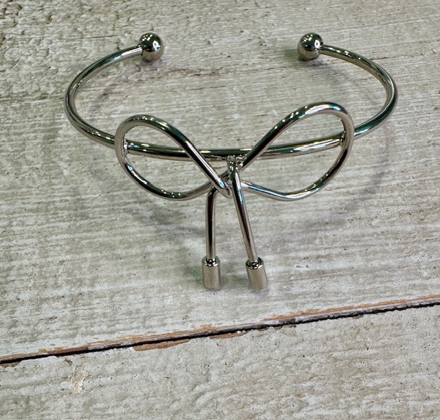 Silver cuff. This open-style bracelet features a dainty bow detail and a sleek, minimal silhouette