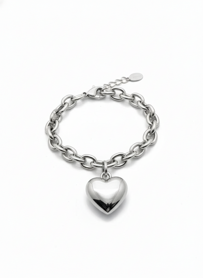 Silver chain bracelet with a heart charm on a white background