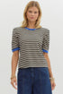 Woman wearing a black and white striped shirt with blue trim on a plain background