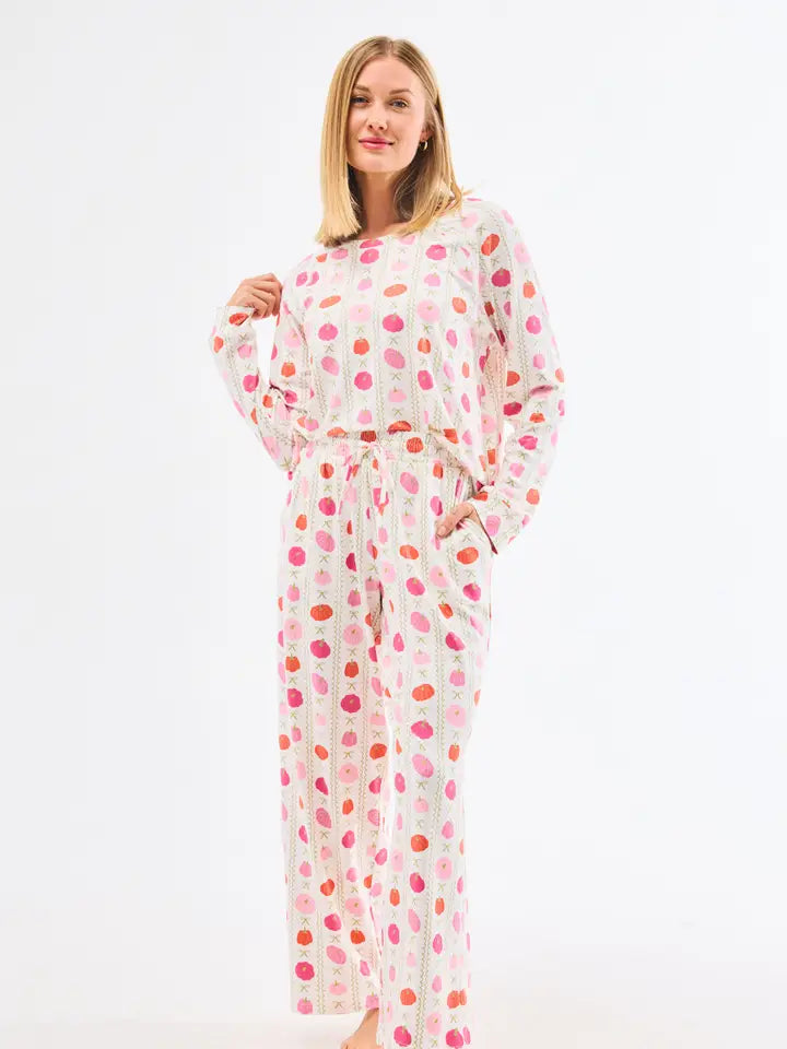 Woman wearing a polka dot pajama set on a white background