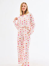 Woman wearing a polka dot pajama set on a white background
