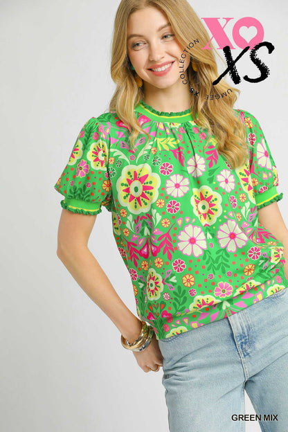 Short puff sleeve pullover in spring green color. It has bright yellow and pink loral design and ruffled neck and sleeves.