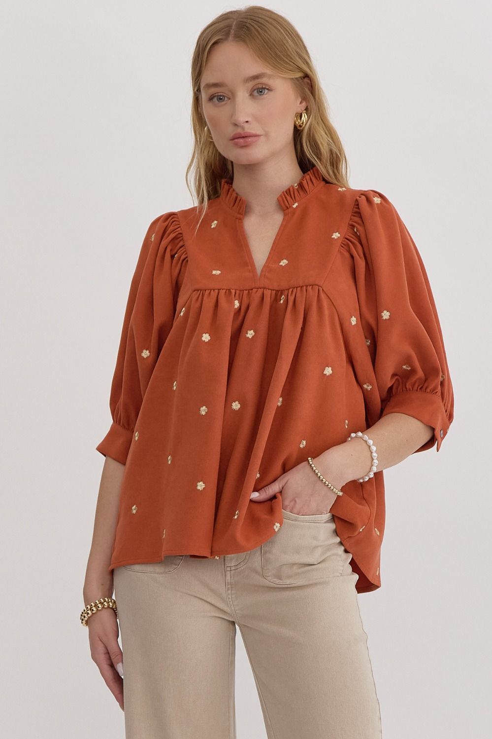 rust v-neck top boasts with gold embroidered florals