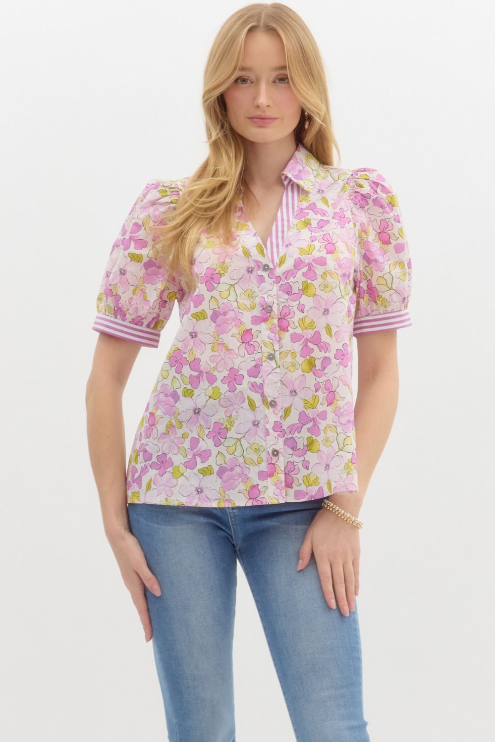 This lightweight blouse features a soft pink floral print with pops of lilac and chartreuse, paired with playful lavender striped accents on the puff sleeves and collar