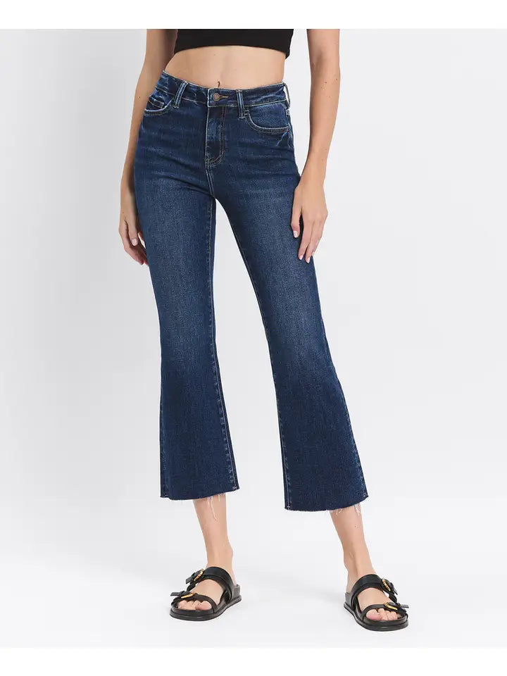 Person wearing dark blue jeans on a white background